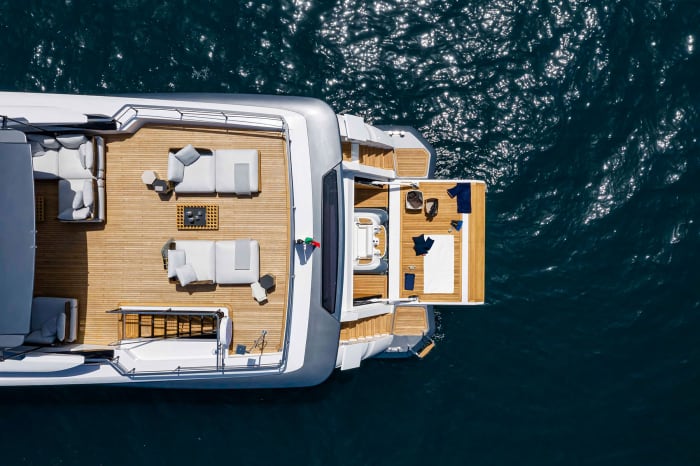 Ferretti’s Dual Mode Transom system consists of two hatches that cleanly cover the stern staircases when underway, and expose them when at anchor. Previous spread: Based on flamed and sandblasted oak, the interior design by Francesco Paszkowski and Margherita Casprini has an elegant, home-away-from-home feeling.
