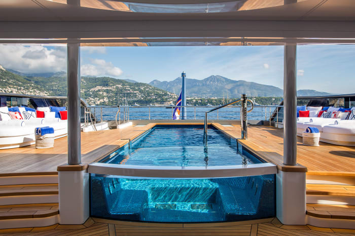 The large pool, which incorporates a hot tub, is recessed into the main deck at the stern.