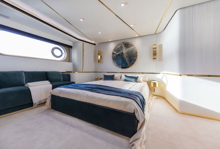The full-beam master stateroom with an art piece by De Cotiis on the wall.