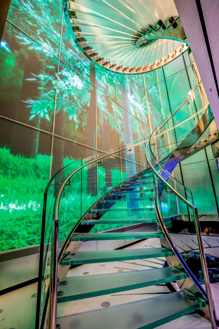 The interactive LED rainforest video wall runs down the five-deck stairwell and out along the main deck.