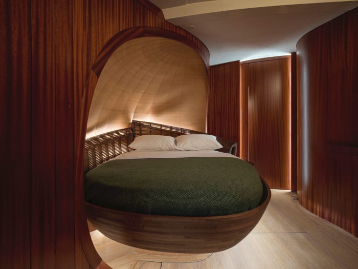 The cocooned VIP suite echoes the compound curves of the master stateroom.