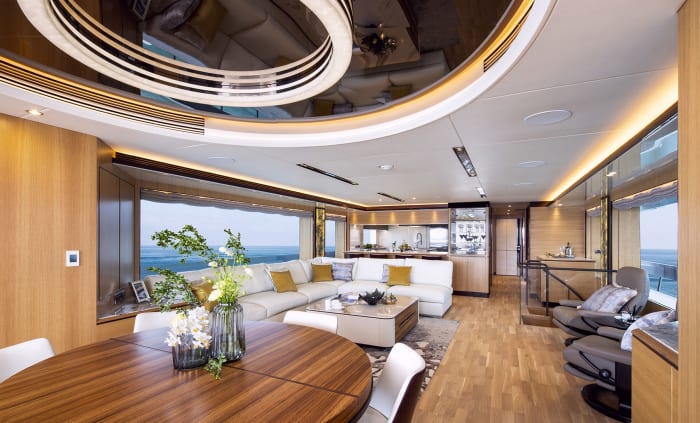 The salon reclaims some aft deck space for indoor dining. The table extends to seat 10.