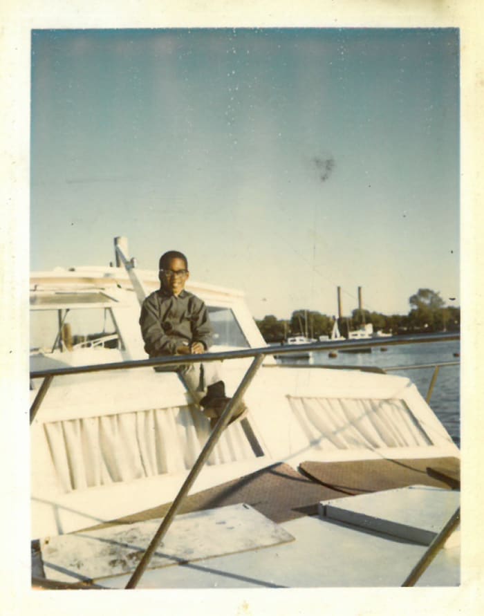 Marshall as a young boy aboard his family’s cabin cruiser. 