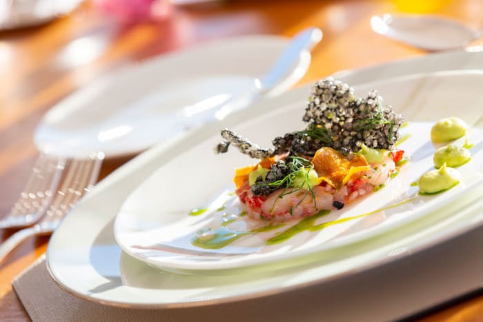 Sicilian red prawn tartar with sweet potato, avocado and a squid ink cracker with dill oil.