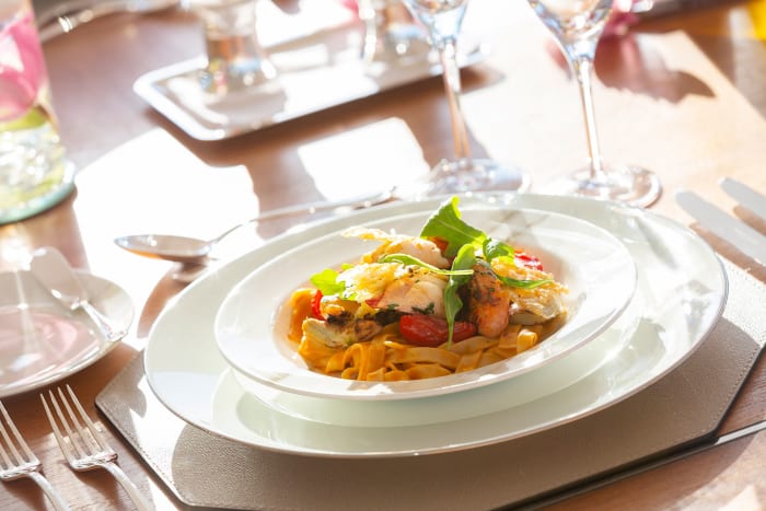Hand-rolled tagliatelle with lobster tail, grilled artichokes and fennel with cherry tomatoes, arugula and basil. 