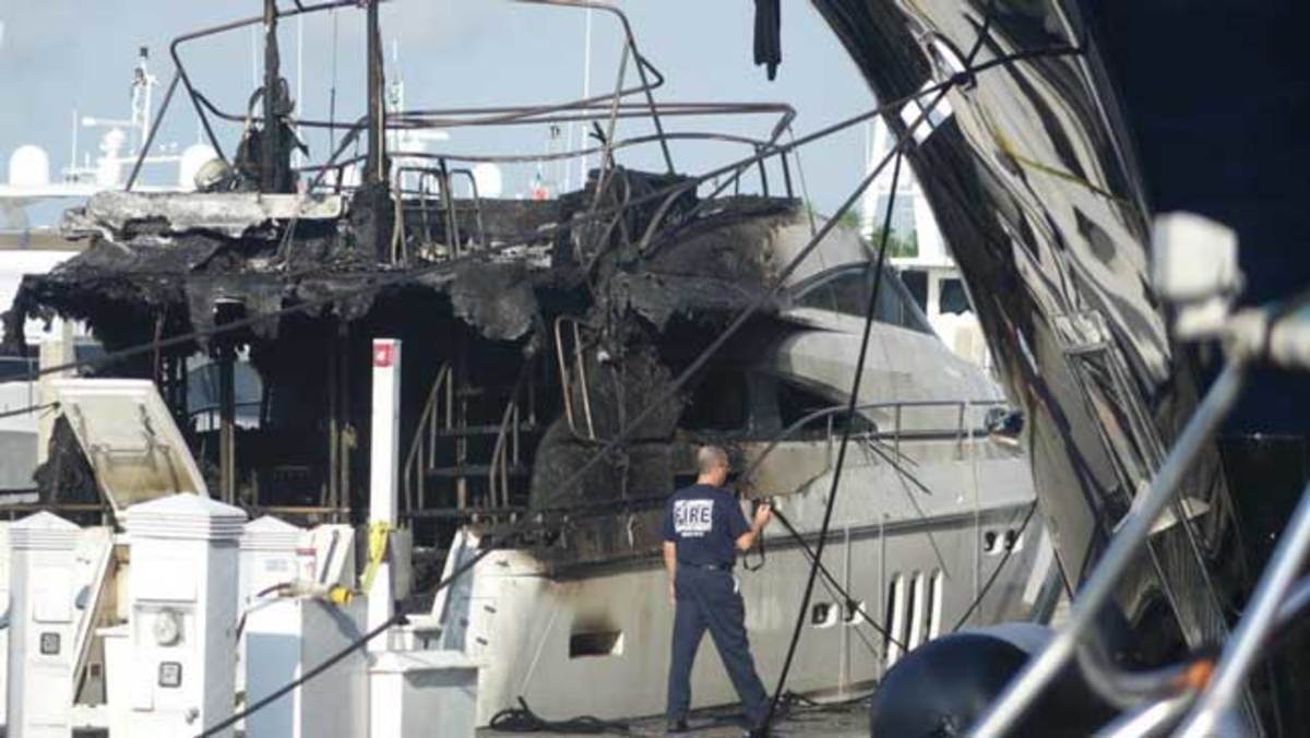 (Joe Cavaretta / Sun Sentinel)  Severely damaged yacht at Bahia Mar as seen on Thursday, Aprl 23, 2015, the morning after fire broke out.