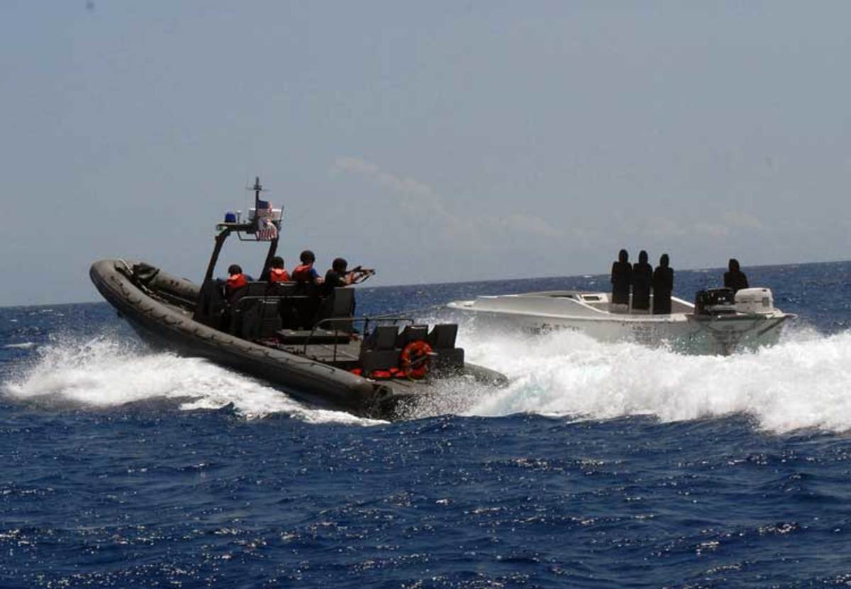 A U.S. Coast Guard Law Enforcement Detachment team conducts a live-fire exercise using a simulated vessel.