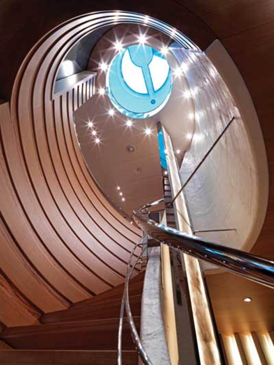 A three-story atrium staircase with a skylight at the top is the focal point of the yacht's interior.