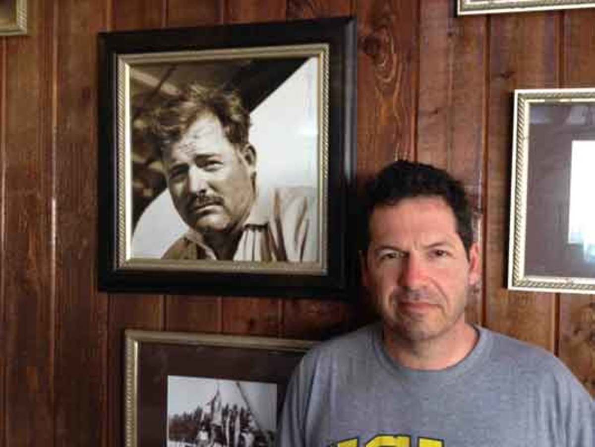 John Hemingway with a photo of his grandfather Ernest