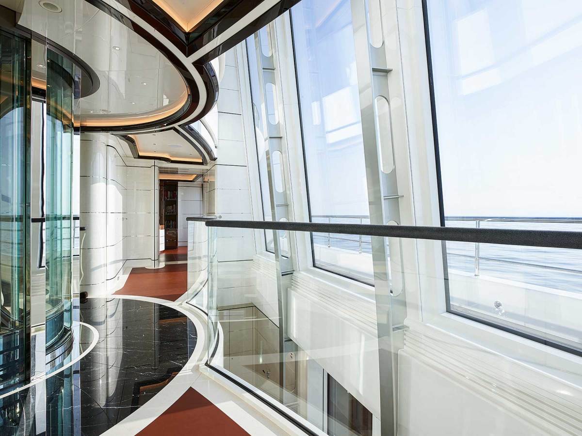 The dramatic atrium spans three decks. Glass is used everywhere, including the elevator.