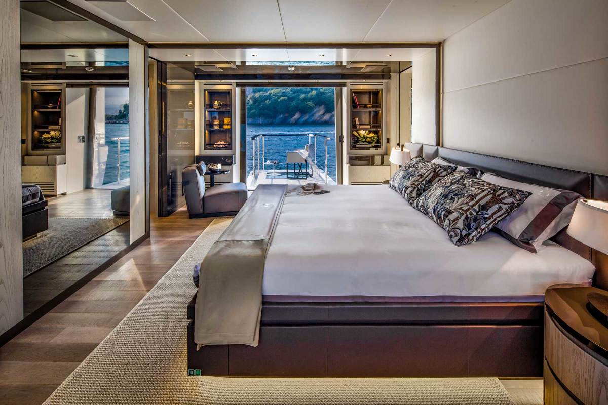 The master stateroom on the main deck forward. The private balcony with pop-up stanchions is deployed at the touch of a button. 