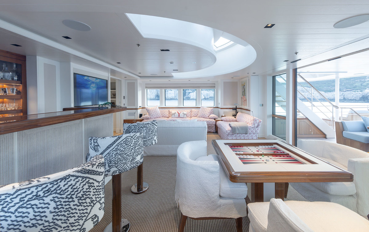 The upper deck lounge with bar, generous seating and games table, is flooded with natural light from the large windows and crescent skylight. 