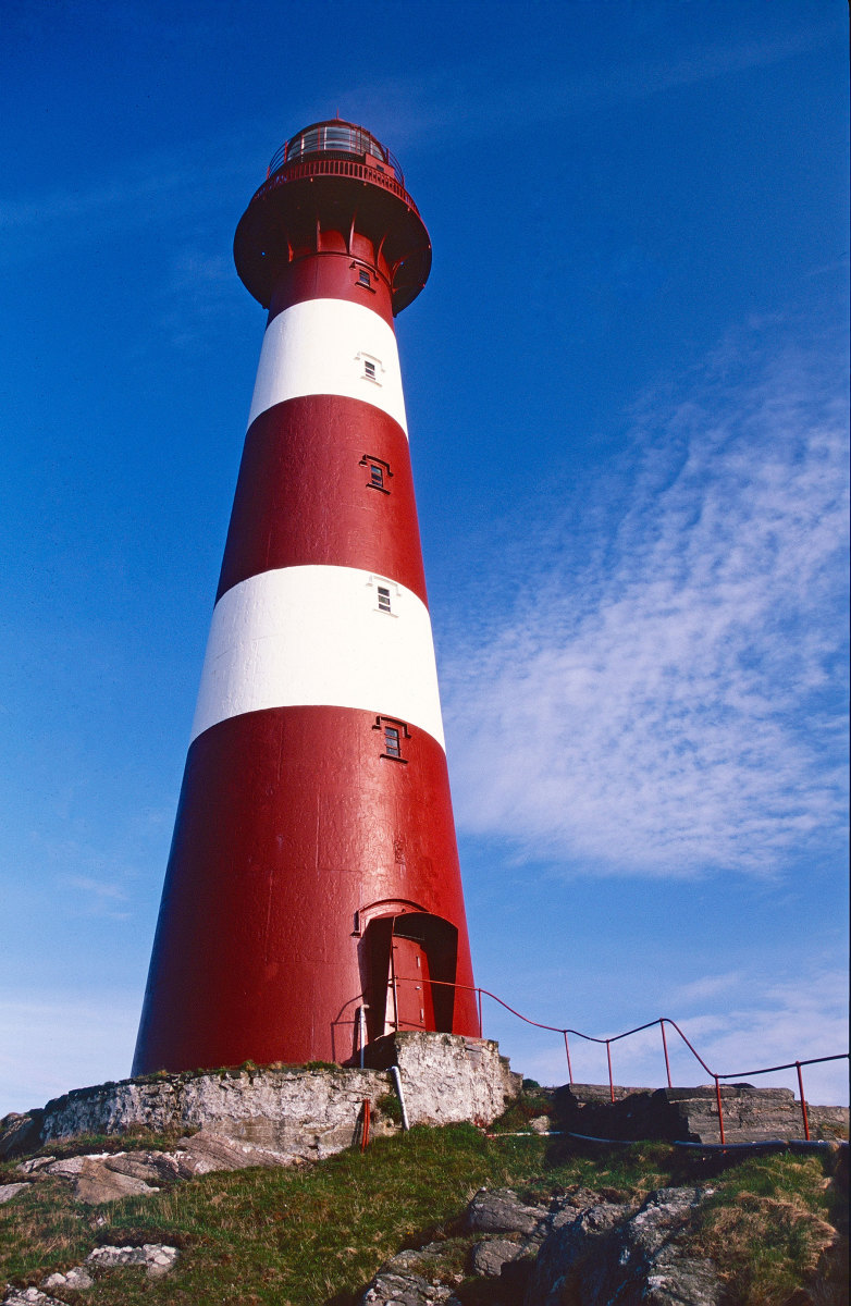 The cast-iron Hellisøy tower is everything you expect from a lighthouse–tall, tapered, red and remote.