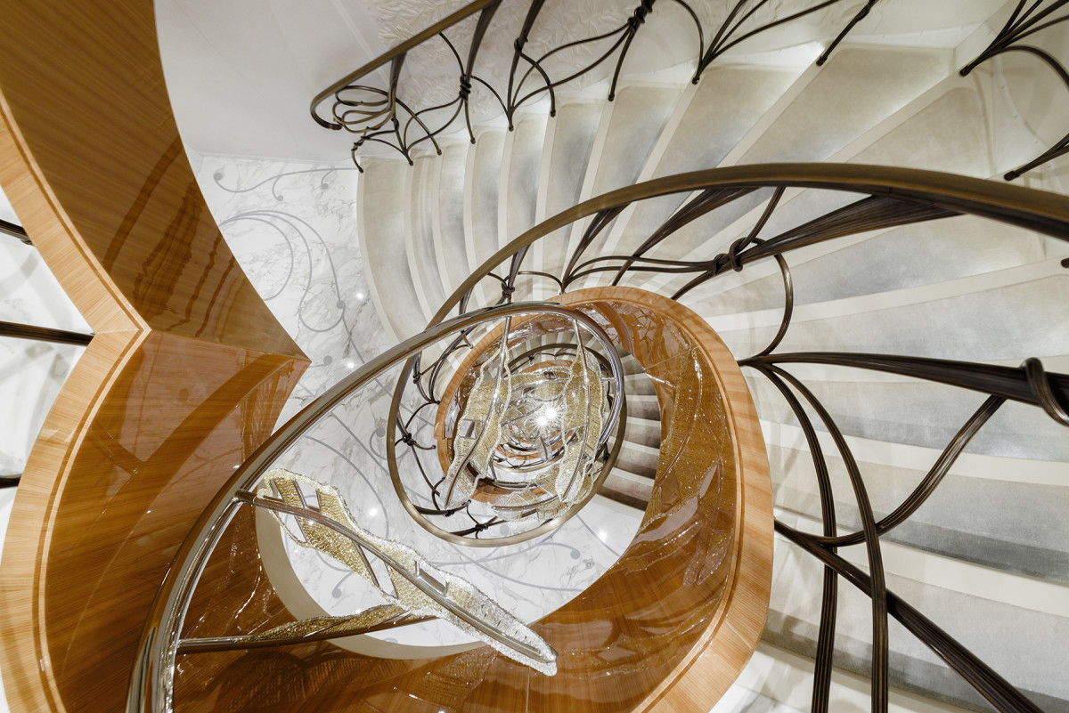 The central staircase showcases a floating sculpture called Falling Feathers. 