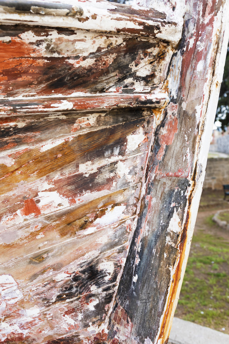 Stripping the paint from an old fishing boat in the fishing village of Vrboska, on the island of Hvar. 